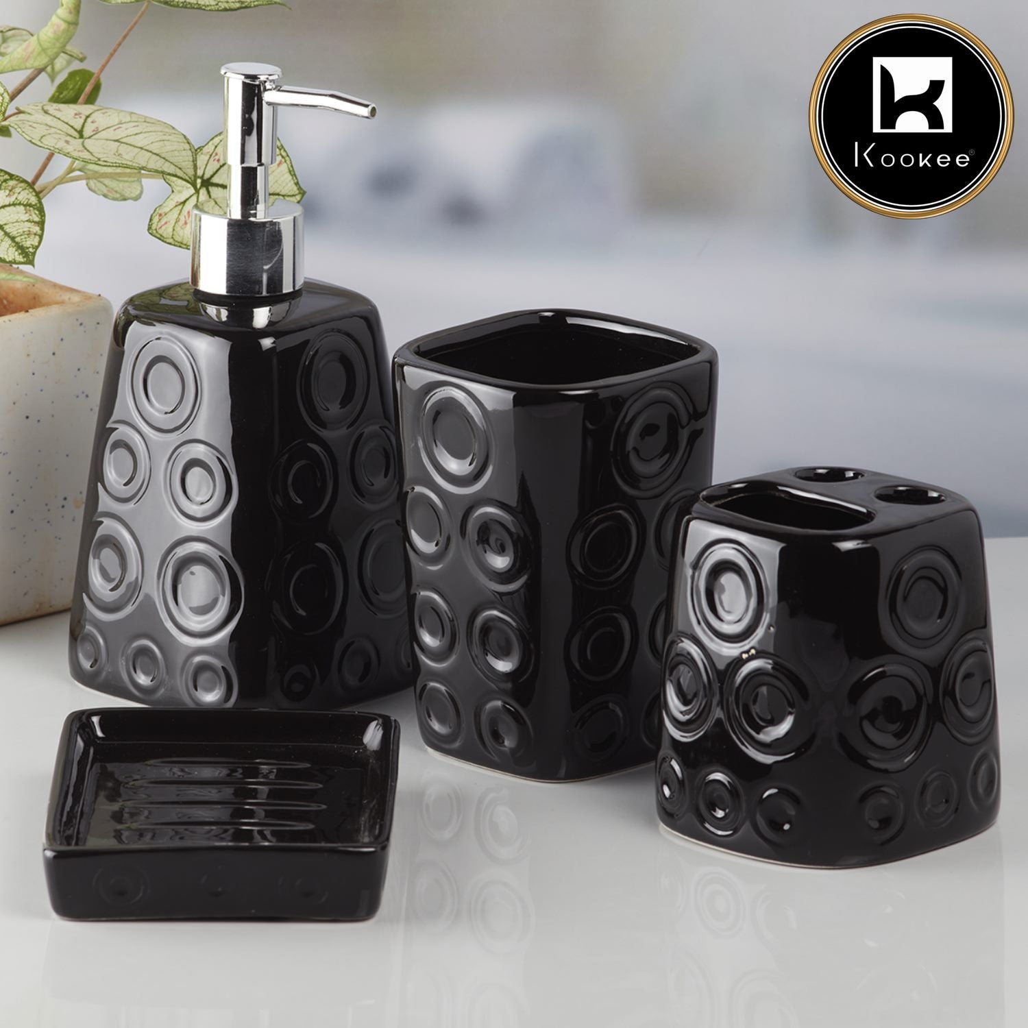 Black bathroom accessory set with circular patterns on a white surface, featuring the Kookee brand.